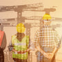 construction workers looking at cranes in the sky