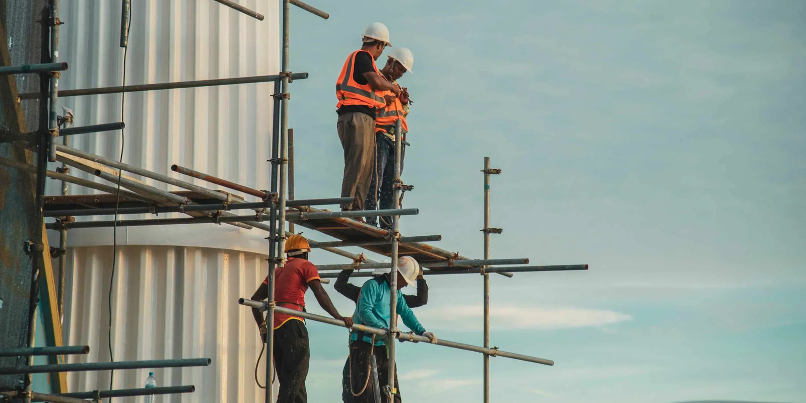 a team of workers on a construction site scaffolding