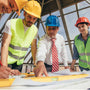 group of consstruction workers looking at plans